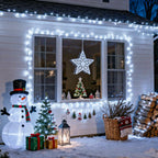 Cool White 100 LED battery string lights outlining a house facade for Christmas