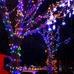 Multicolor 100 LED battery string lights wrapped on a tree with star ornaments