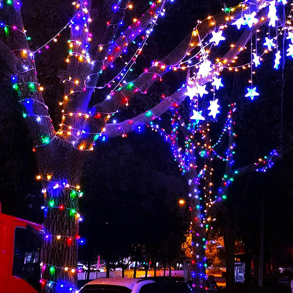 Multicolor 100 LED battery string lights wrapped on a tree with star ornaments