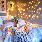 Warm white 100 LED battery string lights draped over a cozy bedroom wall