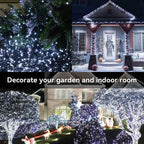 Cool white 100 LED dark green wire string lights decorating a Christmas tree, front porch and garden trees at night