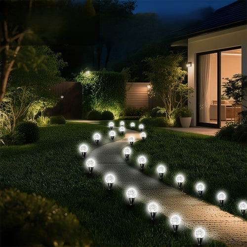 Cool white solar crystal bubble ball stake lights along a garden pathway at night