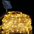 Warm White solar rope lights coiled with solar panel on black background