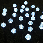 Cool white solar bubble ball light detail close-up at night