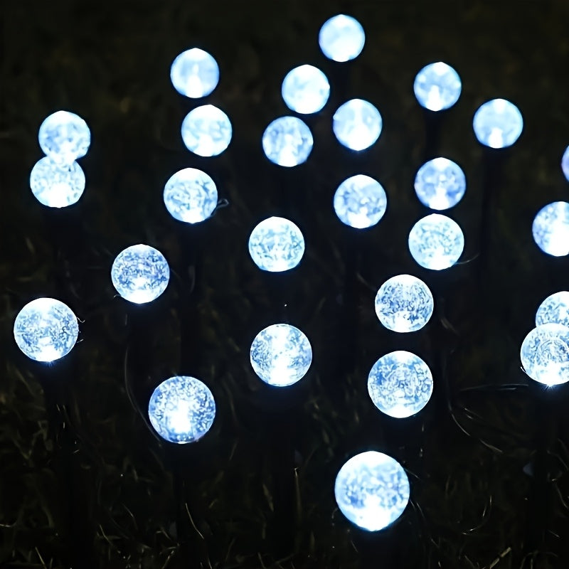 Cool white solar crystal bubble ball stake lights brightening garden pathway at night