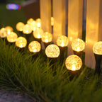 Warm white solar crystal bubble ball stake lights illuminating garden pathway at night