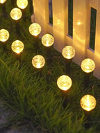 Warm white solar stake lights vertical garden scene at night